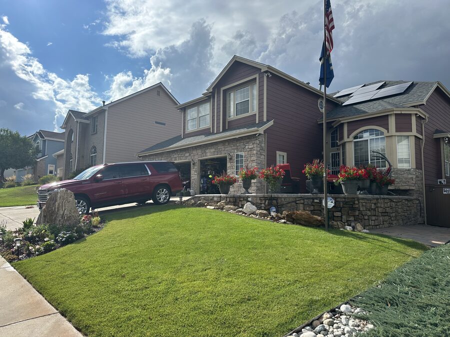 Healthy green residential front lawn maintained by Metropolitan Total Property in Colorado