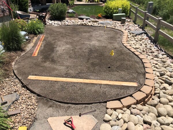 Shaped and compacted base with paver edging complete and screed rails laid out